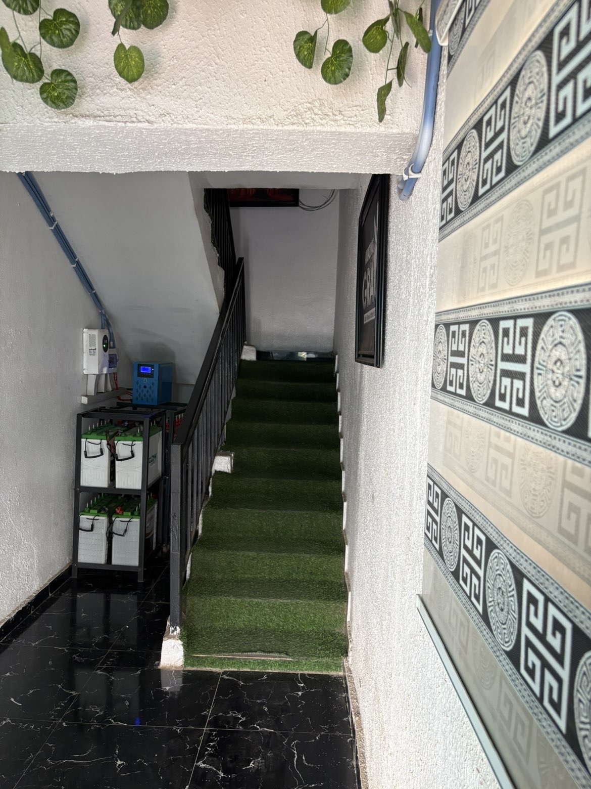 Interior stair hall with inverter and battery bank