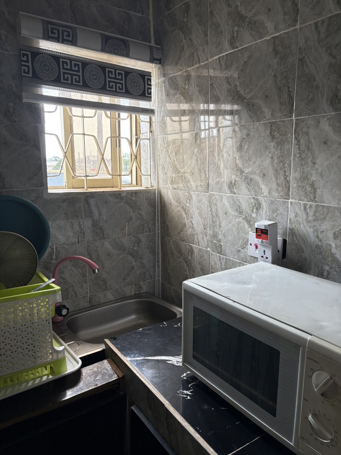 Fitted apartment kitchen with sink and microwave