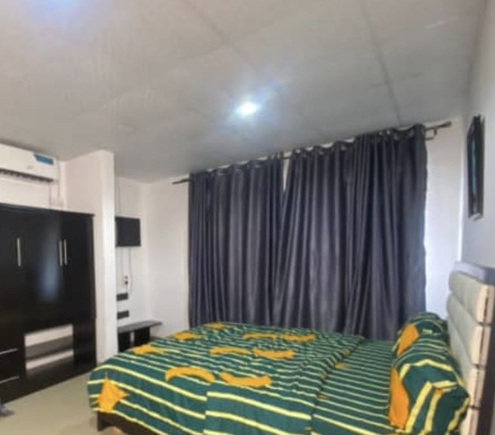 Studio suite bedroom with wardrobe and air conditioning